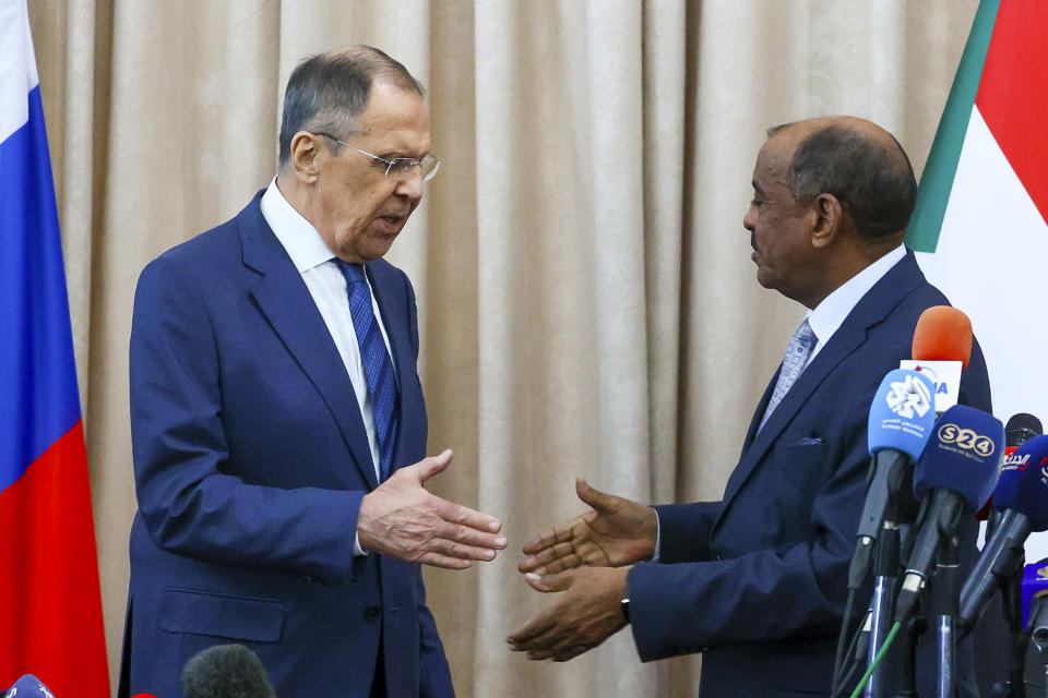 In this photo released by the Russian Foreign Ministry Press Service, Russian Foreign Minister Sergey Lavrov, left, and Sudanese Foreign Minister Maryam al-Sadiq al-Mahdi shake hands after a joint news conference following their talks in Khartoum, Sudan, on Thursday, Feb. 9, 2023. (Russian Foreign Ministry Press Service via AP)