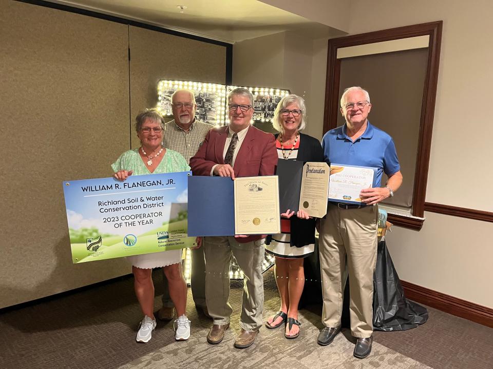 William R. Flanagan Jr. (center) was recently awarded the Richland Soil and Water Conservation District (Richland SWCD) Cooperator of the Year award. He is seen here with Nature Park volunteers (from left) Barb Keller, Howard Harriman, his wife Tonya, and Doug Versaw.