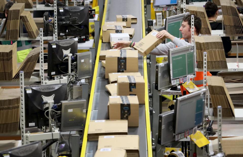 An amazon delivery worker prepares parcels during the Black Friday rush: PA