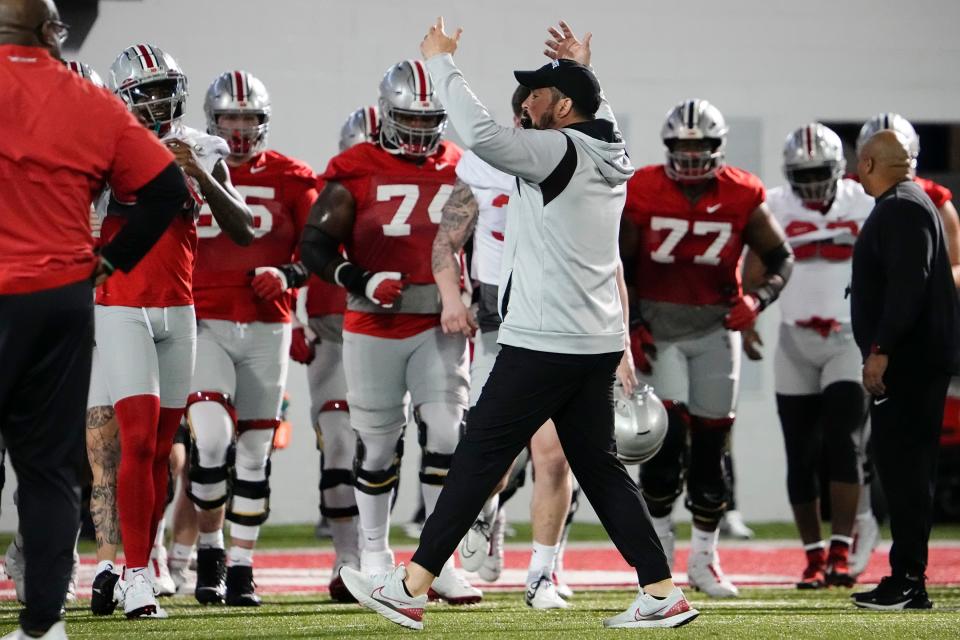 Mar 7, 2023; Columbus, Ohio, USA;  Ohio State Buckeyes head coach Ryan Day gathers his players into a huddle at the start of the first day of spring football drills. Mandatory Credit: Adam Cairns-The Columbus Dispatch