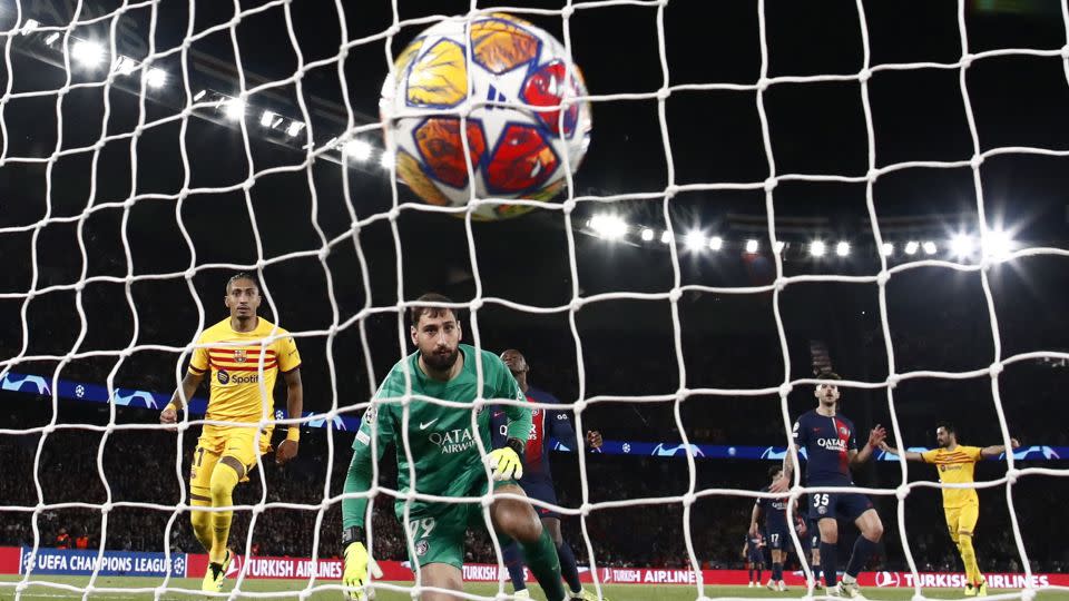 Raphinha (L) scores his and Barcelona's second goal of the game. - Sarah Meyssonnier/Reuters