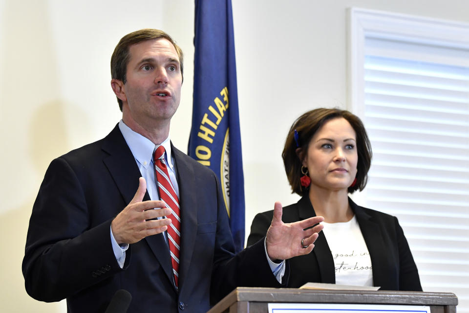 Kentucky Governor-Elect Andy Beshear, left, and his Lt. Governor Jacqueline Coleman speak with reporters following the concession of incumbent Governor Matt Bevin in Frankfort, Ky., Thursday, Nov. 14, 2019. In a recanvass, Beshear defeated Bevin by 5136 votes. (AP Photo/Timothy D. Easley)