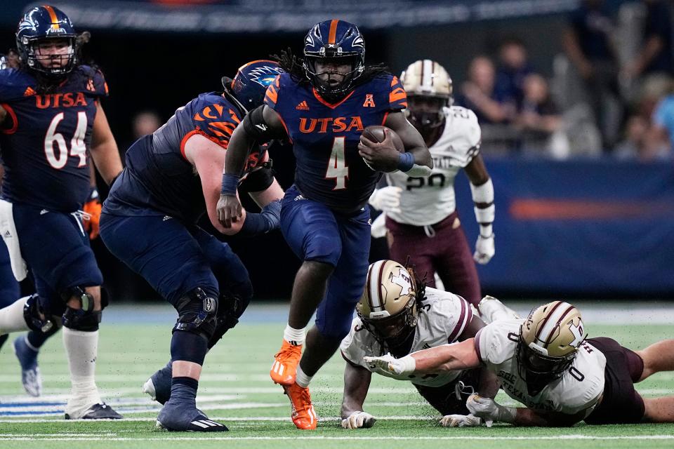 UTSA running back Kevorian Barnes breaks free from Texas State defenders during the first half of the Roadrunners' 20-13 win Saturday night at the Alamodome. UTSA improved to 5-0 over the Bobcats in their I-35 Rivalry series.