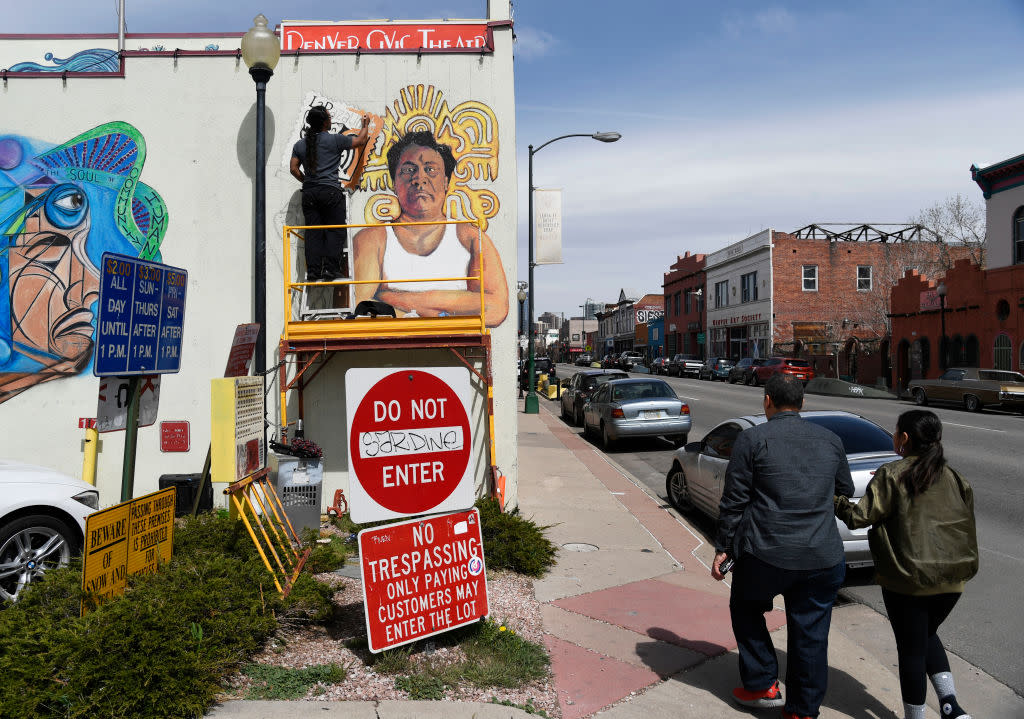 Adolfo Romero paints a mural of <em>desaparecido</em> Oscar Zeta Acosta on Denver’s Su Teatro performing arts center in 2018. (Credit: Andy Cross/The Denver Post via Getty Images)