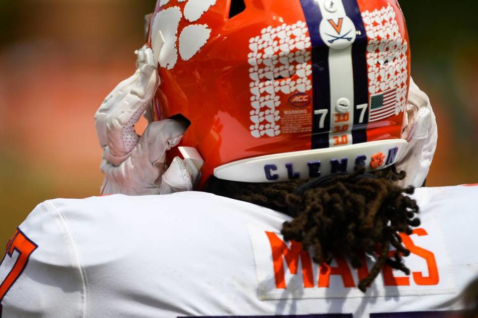 Clemson offensive lineman Mitchell Mayes (77) puts his helmet on during the annual Orange and White Spring game at Memorial Stadium in Clemson, S.C. Saturday, April 15, 2023.