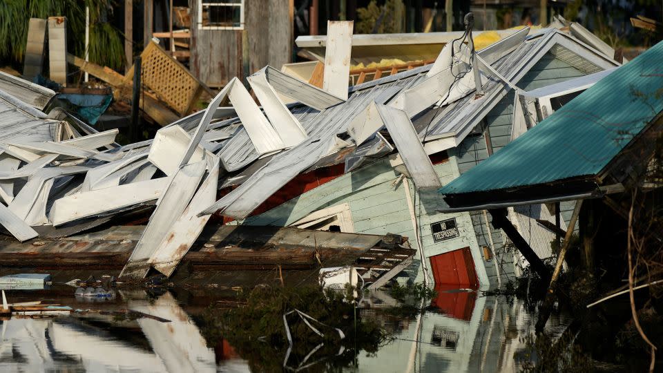 An unstilted home that came off its blocks sits partially submerged in a canal in Horseshoe Beach, Florida, on September 1, two days after Hurricane Idalia hit. - Rebecca Blackwell/AP