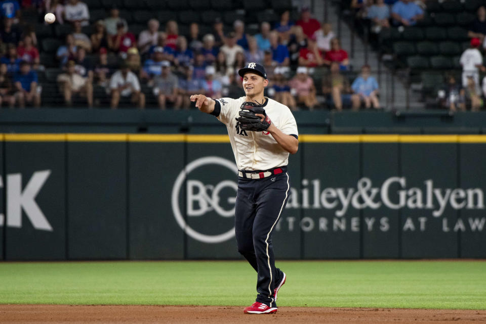 Texas Rangers shortstop Corey Seager throws to first base for an out in the bottom of the first inning in a baseball game against the Cleveland Guardians in Arlington, Texas, Saturday, July 15, 2023. (AP Photo/Emil T. Lippe)