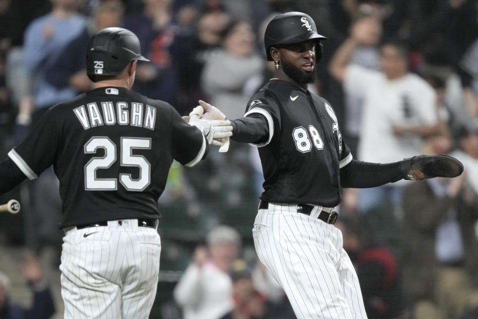 Chicago White Sox's Luis Robert Jr. (88) celebrates with Andrew Vaughn after Robert scored on Yoan Moncada's single off Cleveland Guardians starting pitcher Shane Bieber during the fifth inning of a baseball game Tuesday, May 16, 2023, in Chicago. (AP Photo/Charles Rex Arbogast)