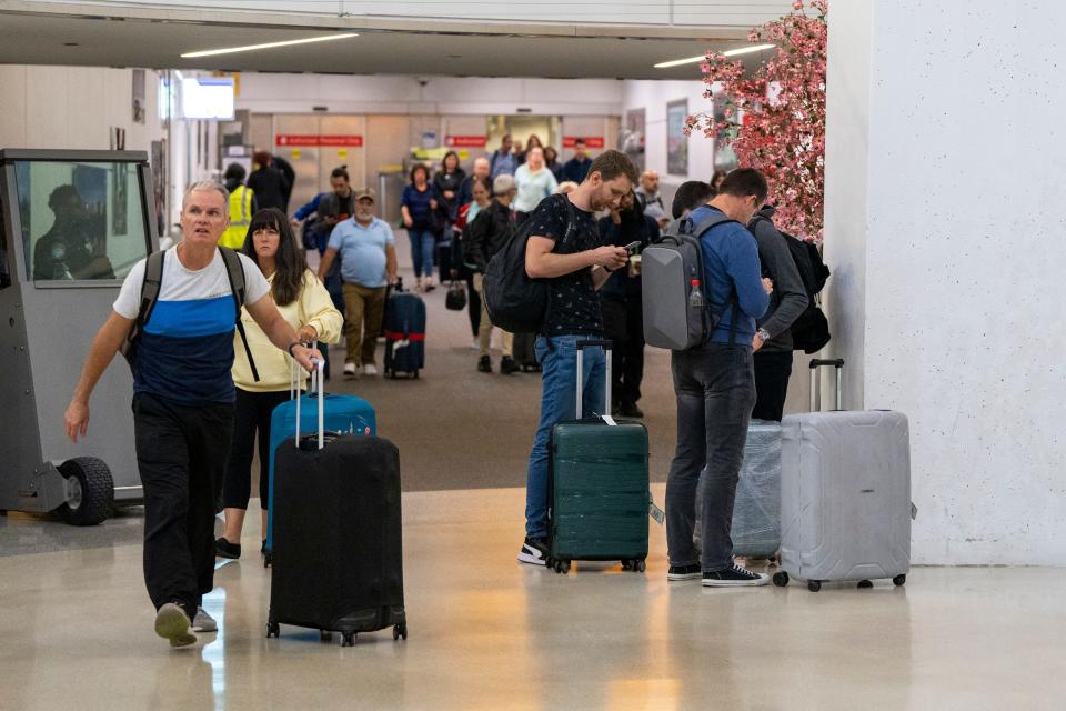 Passengers including some on a flight from Israel arrive at Newark Airport on Friday, October 13, 2023.