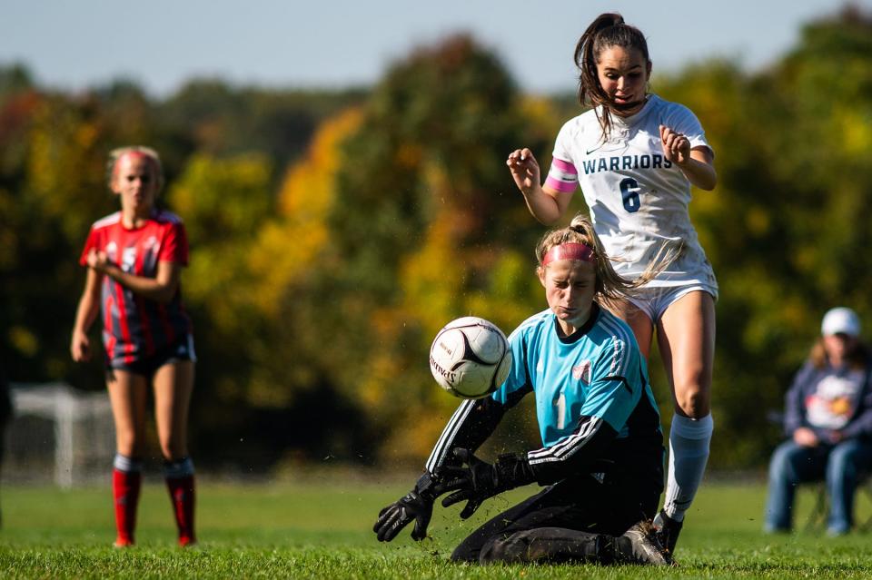 Red Hook keeper Isabella Faraldi stops the ball while colliding with Lourdes' Grace Morra during an October 15, 2022 girls soccer game.