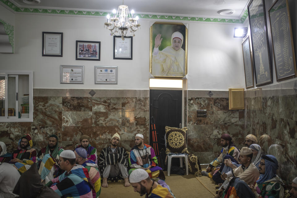 Members of the Sufi Karkariya order chant hymns during a religious celebration of the birthday of the prophet Muhammed, in Aroui, near Nador, eastern Morocco, Monday, Oct. 18, 2021. (AP Photo/Mosa'ab Elshamy)