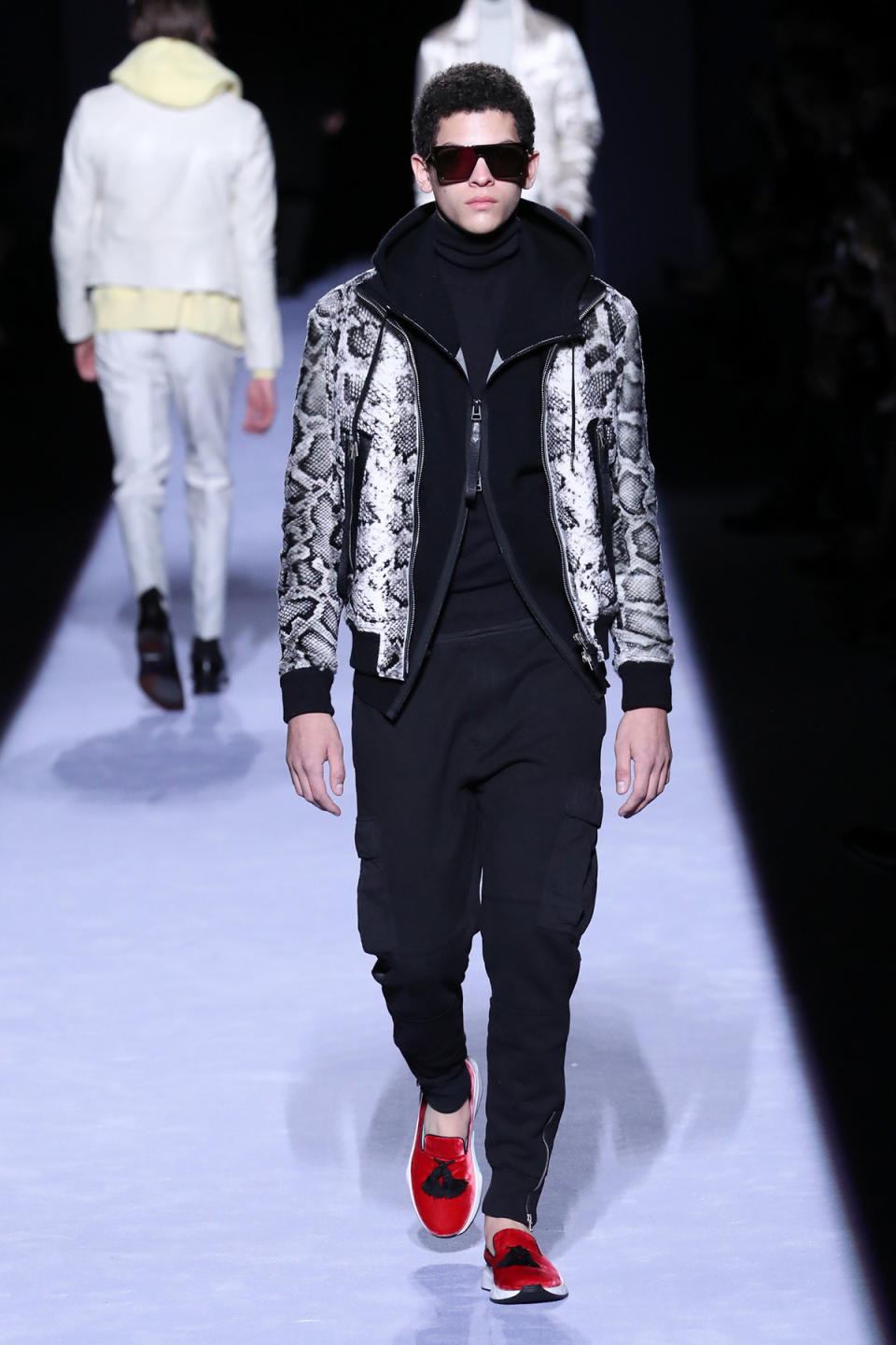 <p>A model wears a hybrid between a slipper and a sneaker to complement his fashion forward athleisure look, all desgined by Tom Ford. (Photo: Getty Images) </p>