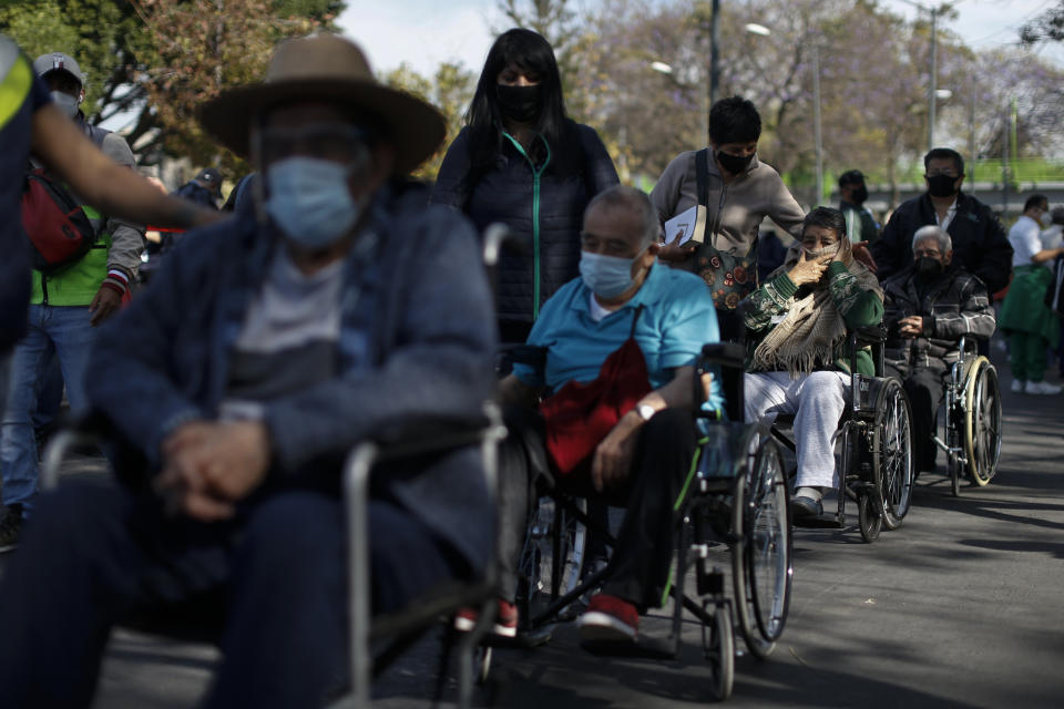 FILE - In this Feb. 24, 2021, file photo, elderly residents of the Iztacalco borough wait in line to receive doses of the Russian COVID-19 vaccine Sputnik V, during a mass vaccination campaign for Mexicans over age 60, at the Advanced School for Physical Education, in Mexico City. (AP Photo/Rebecca Blackwell, File)