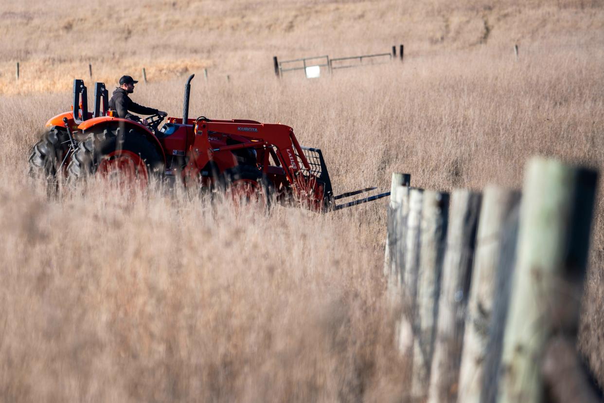 Farm manager Sam Applegate operates a tractor at In Harmony farm on Nov. 30, 2023, in Earlham.