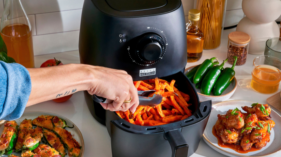 Bella Pro analog air fryer with curly sweet potato fries in kitchen