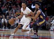 Portland Trail Blazers guard Tim Quarterman, left, dribbles past New Orleans Pelicans guard Quinn Cook during the second half of an NBA basketball game in Portland, Ore., Wednesday, April 12, 2017. The Pelicans won 103-100. (AP Photo/Craig Mitchelldyer)