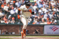 San Francisco Giants' Patrick Bailey watches his hit as he runs to first base during the third inning of a baseball game against the Arizona Diamondbacks, Saturday, April 20, 2024, in San Francisco. (AP Photo/Nic Coury)