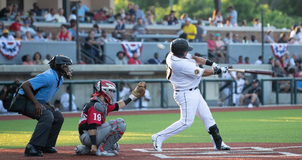 Gastonia Honey Hunters catcher Ermindo Escobar takes a swing during his team's season opener against the Lancaster Barnstormers.