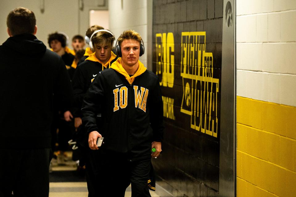 Iowa's Max Murin walks down to the mat with teammates before a NCAA wrestling dual against California Baptist, Sunday, Nov. 13, 2022, at Carver-Hawkeye Arena in Iowa City, Iowa. 