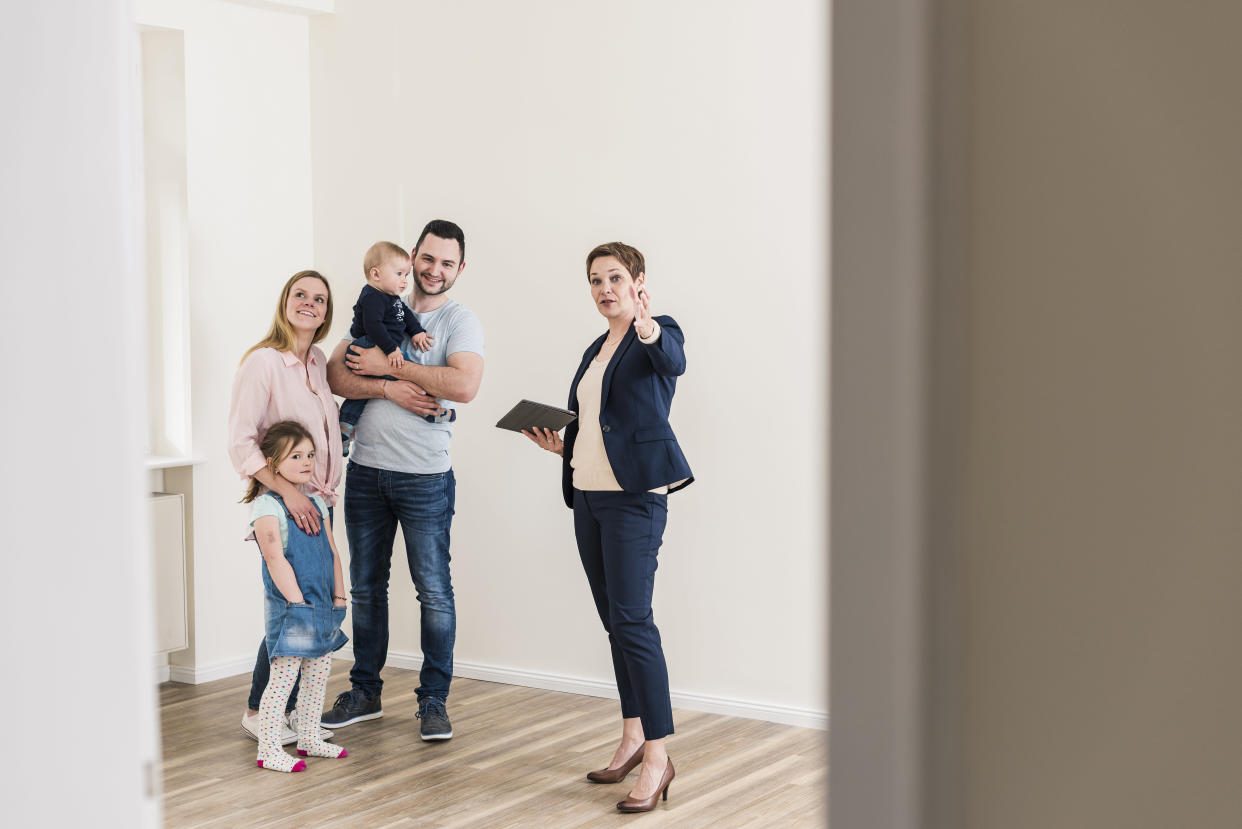 Real estate agent and family in new apartment