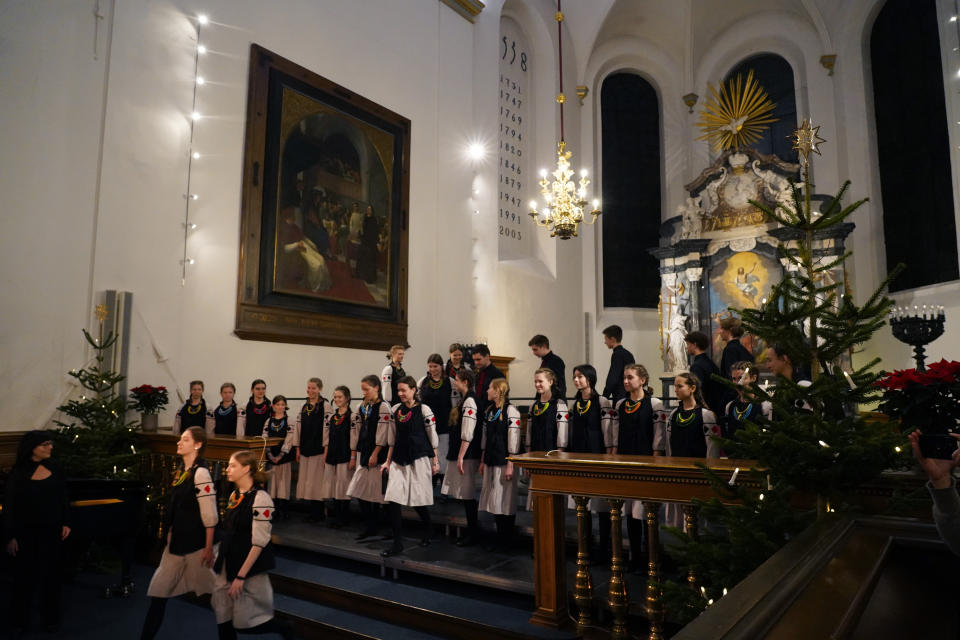 Shchedryk youth choir members leave the stage, following a Christmas concert at Copenhagen’s Church of the Holy Spirit, in Copenhagen, Denmark, Thursday, Dec. 8 2022. The Shchedryk ensemble, described as Kyiv’s oldest professional children’s choir, were in the Danish capital this week for a performance as part of an international tour that also took them to New York’s famed Carnegie Hall. (AP Photo/James Brooks)