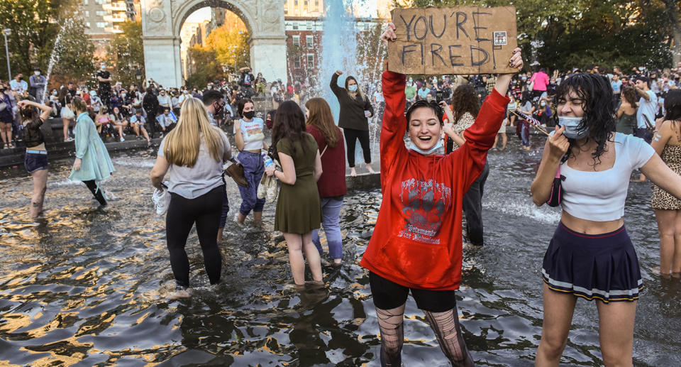 People stand in the fountain as they celebrate in Washington Square Park after it was announced that Democratic nominee Joe Biden would be the next U.S. President on November 7, 2020 in New York City.