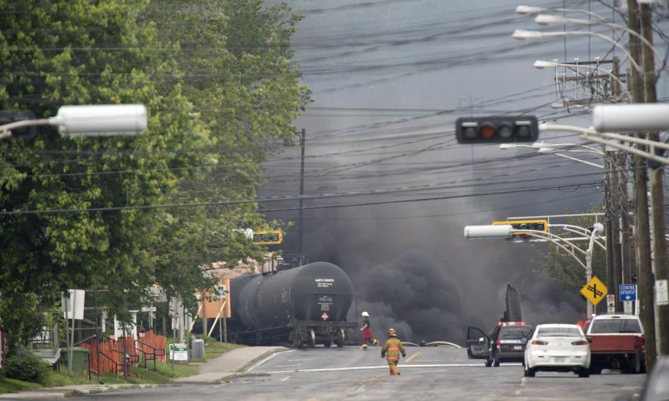 Smoke rises from railway cars that were carrying crude oil after derailing in downtown Lac-Mégantic, Que. in July 2013. THE CANADIAN PRESS/Paul Chiasson