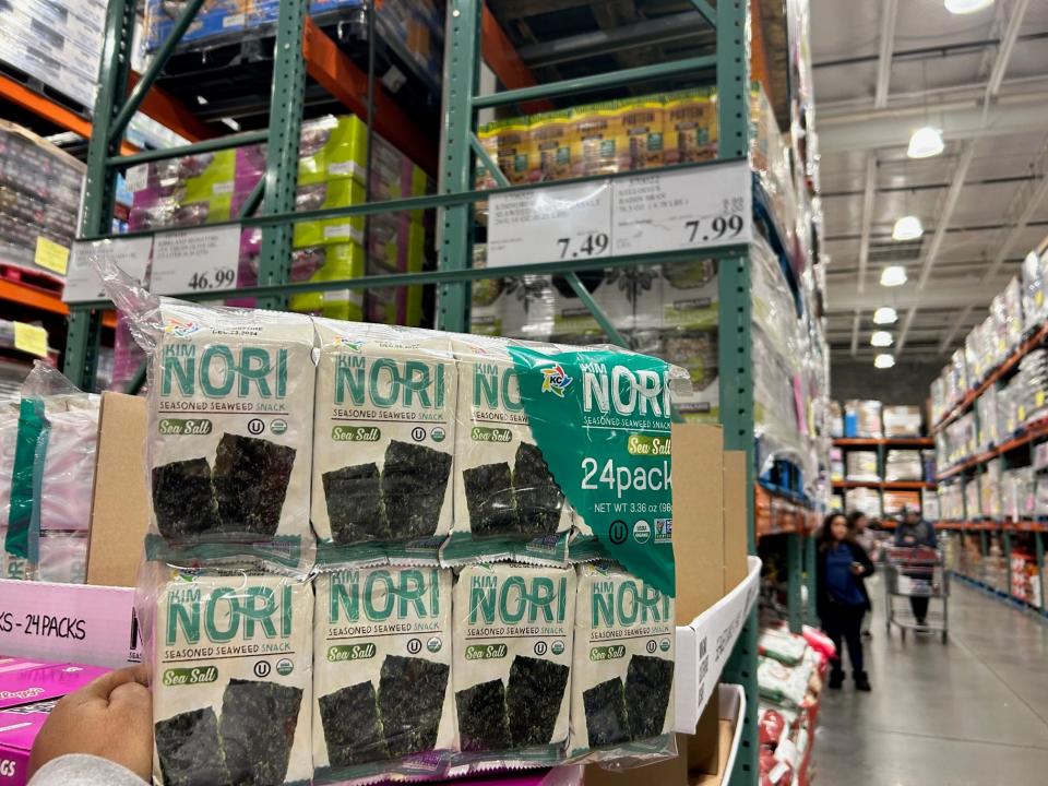 hand holding up a bulk pack of nori seaweed at costco