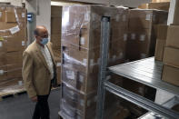 Caretaker Health Minister Hamad Hassan, walks inside a medical warehouse in Beirut, Lebanon, Friday, June 11, 2021. Hassan raids warehouses in an effort to control those who are hoarding subsidized medical equipment and baby formula in order to sell them later at higher prices or on the black market. (AP Photo/Bilal Hussein)