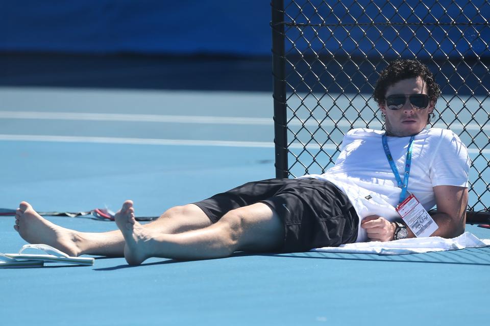 BRISBANE, AUSTRALIA - DECEMBER 29: Rory McIlroy watches Caroline Wozniacki during a practice session on December 29, 2012 in Brisbane, Australia. (Photo by Chris Hyde/Getty Images)