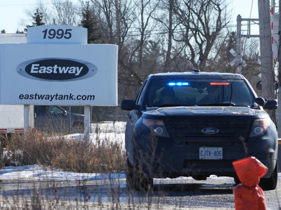 A police cruiser is shown at the entrance to Eastway Tank Pump &amp; Meter Ltd. in Ottawa on Friday as investigators continued to look into the fatal explosion and fire that left several of the company&#39;s employees dead. (Sean Kilpatrick/The Canadian Press - image credit)