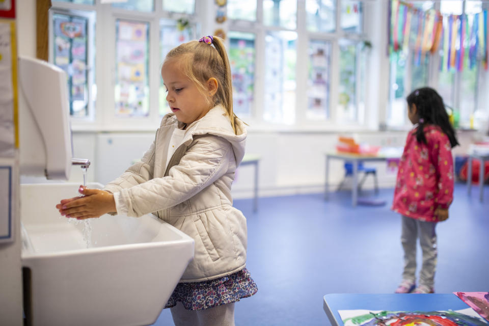 LONDON, ENGLAND - JUNE 10: A child maintains social distancing measures while washing hands ahead of a lesson at Earlham Primary School, which is part of the Eko Trust on June 10, 2020 in London, England. As part of Covid-19 lockdown measures, Earlham Primary School is teaching smaller ‘bubbles’ of students, to help maintain social distancing measures. School staff have put into place many safety measures such as corridor signage for a one way system, regular supervised handwashing, temperature checks on arrival and enhanced cleaning regimes to keep pupils and staff as safe as possible. Bubbles of pupils are limited to six and each have their own well-ventilated space. The Government have announced it is set to drop plans for all English primary pupils to return to school before the end of the summer. (Photo by Justin Setterfield/Getty Images)