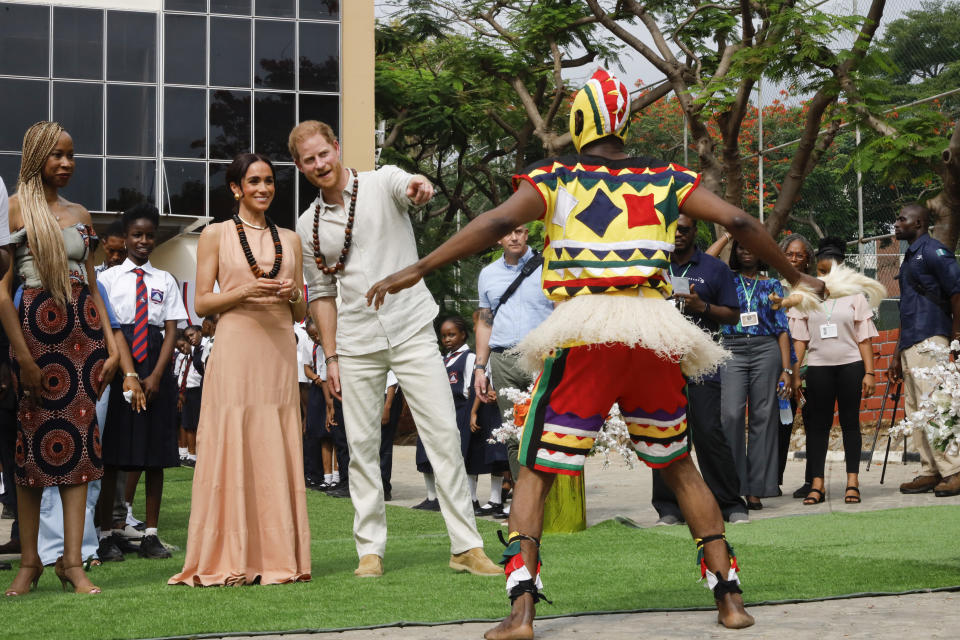 Prince Harry, Duke of Sussex and Meghan, Duchess of Sussex visit Lightway Academy in Nigeria wearing formal dress shoes