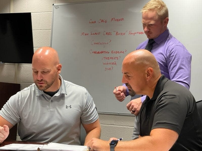 Sgt. Bill Patterson, Detective Ryan Patterson (back) and Lt. Sam Williams discuss the 1990 cold case murder of James Bradley.