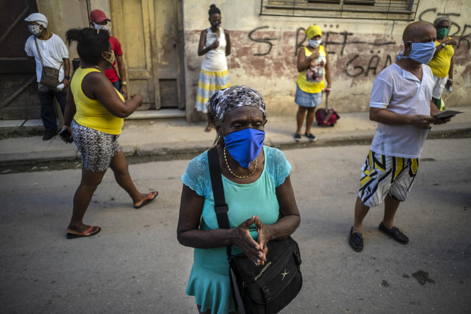 People wearing face masks amid the new coronavirus pandemic pray during a Catholic Mass broadcast by radio in honor of the Virgin of Charity of Cobre, on her feast day in Havana, Cuba, Tuesday, Sept. 8, 2020. The virgin is Cuba's Catholic patron saint. (AP Photo/Ramon Espinosa)