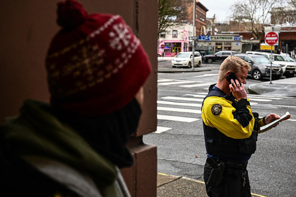 Portland Police officer Eli Arnold writes a ticket for smoking drugs in public (Patrick T. Fallon / AFP via Getty Images file)