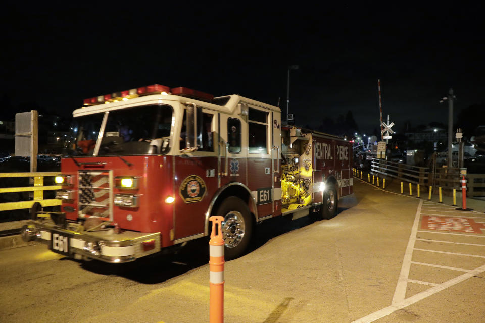 Ffire trucks drive toward a ferry boat headed to Ketron Island, Friday, Aug. 10, 2018, at the ferry terminal in Steilacoom, Wash. An airline mechanic stole an empty Horizon Air turboprop plane, took off from Seattle-Tacoma International Airport and was chased by military jets before crashing onto Ketron, a small island in the Puget Sound, on Friday night, officials said. (AP Photo/Ted S. Warren)