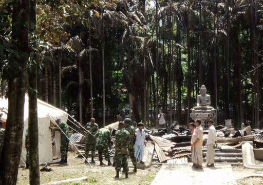 Soldiers from the Bangladesh Army erect tents at the torched Lal Ching Buddhist temple at Ramu, on October 1, 2012. Bangladesh police have arrested nearly 300 people after Muslim mobs attacked temples and houses in what Buddhist leaders described as the worst violence against the community since independence