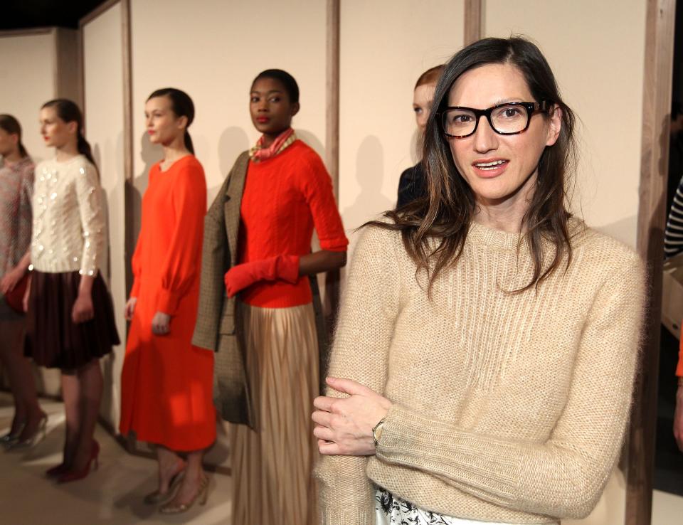 Jenna Lyons poses in front of models at a runway show