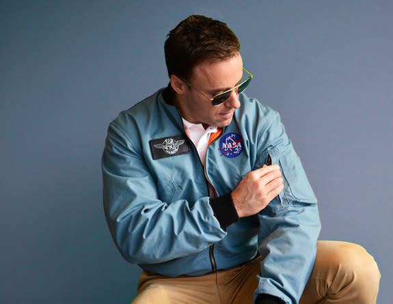 A model poses wearing Still The Right Stuff's replica Apollo flight jacket, which faithfully reproduces the iconic NASA coat.