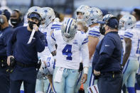 Dallas Cowboys quarterback Dak Prescott (4) stands on the sideline with coaches during the second half of an NFL football game against the Seattle Seahawks, Sunday, Sept. 27, 2020, in Seattle. The Seahawks won 38-31. (AP Photo/John Froschauer)