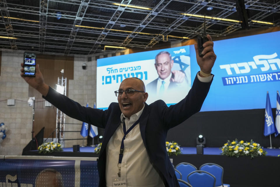 A supporter of Benjamin Netanyahu, former Israeli Prime Minister and the head of Likud party celebrates the first exit poll results for Israel's election, at the Likud party headquarters in Jerusalem, Tuesday, Nov. 1, 2022. (AP Photo/Maya Alleruzzo)