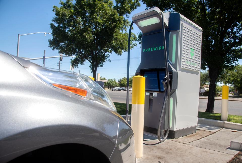 A Nissan Leaf electric vehicle charges at a ChargePoint charging station at the Arco AM/PM gas station Wednesday at March and West lanes in Stockton.