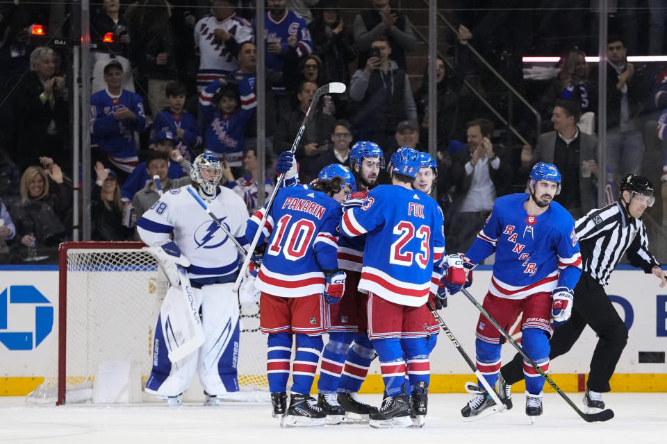 Tampa Bay Lightning goaltender Andrei Vasilevskiy (88) watches as New York Rangers' Chris Kreider (20) celebrates with teammates after scoring a goal during the first period of an NHL hockey game Wednesday, April 5, 2023, in New York. (AP Photo/Frank Franklin II)