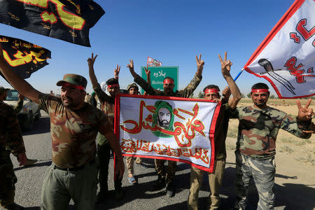 FILE PHOTO: Shi'ite Popular Mobilization Forces (PMF) celebrate on the outskirts of Kirkuk, Iraq October 17, 2017. REUTERS/Alaa Al-Marjani/File Photo