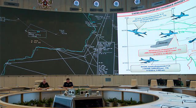 Lieutenant-General Andrey Kartopolov, head of main operational department of Russian military's General Staff, left, speaks to the media during a news conference in Moscow. Photo: AP.