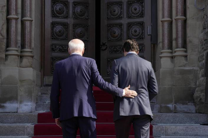 Prime Minister Justin Trudeau and U.S. President Joe Biden officially arrive at Parliament Hill, in Ottawa, Canada, on Friday, March 24, 2023. (Adrian Wyld/The Canadian Press via AP)