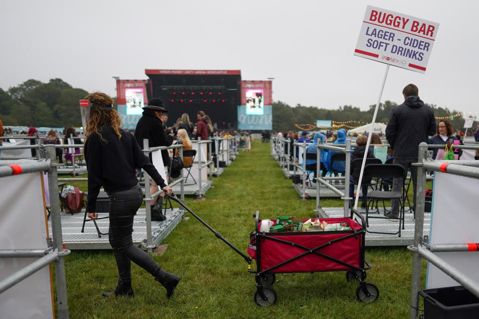 An employee wheels a mobile drink trolley between socially distanced enclosures ahead of Sam Fender performing at the Virgin Money Unity Arena on Aug. 13 in Newcastle upon Tyne, England. Sam Fender is the first to perform at the socially distanced music venue.  (Photo: Ian Forsyth via Getty Images)