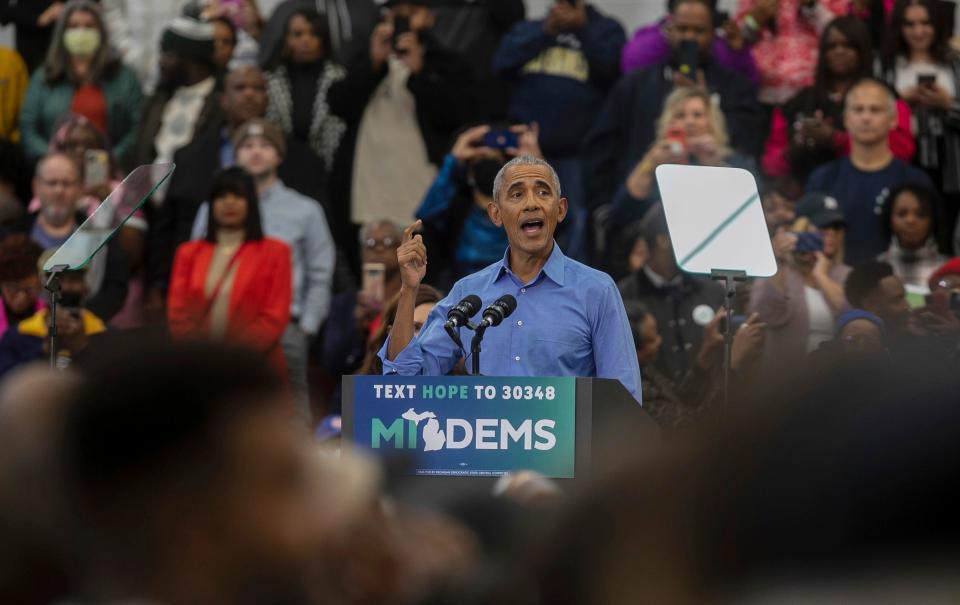 Former President Barack Obama talks in front of a large crowd during a rally inside a gymnasium at Renaissance High School in Detroit on Saturday, Oct. 29, 2022. 