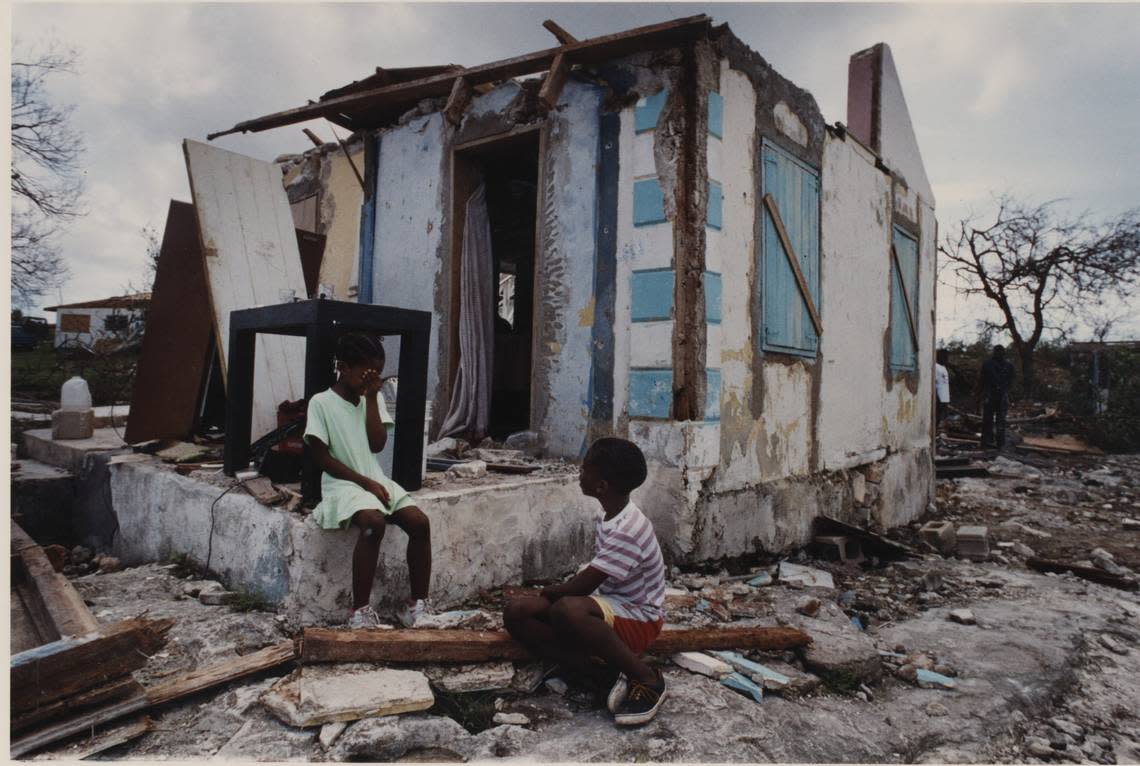 In this file photo from August 1992, a Bahamian girl cries as she sits on all that’s left of a house after Hurricane Andrew hit the islands. Andrew ravaged the Bahamas’ North Eleuthera, New Providence, North Andros, Bimini and Berry islands before making landfall in South Miami-Dade, Florida on Aug. 24, 1992.